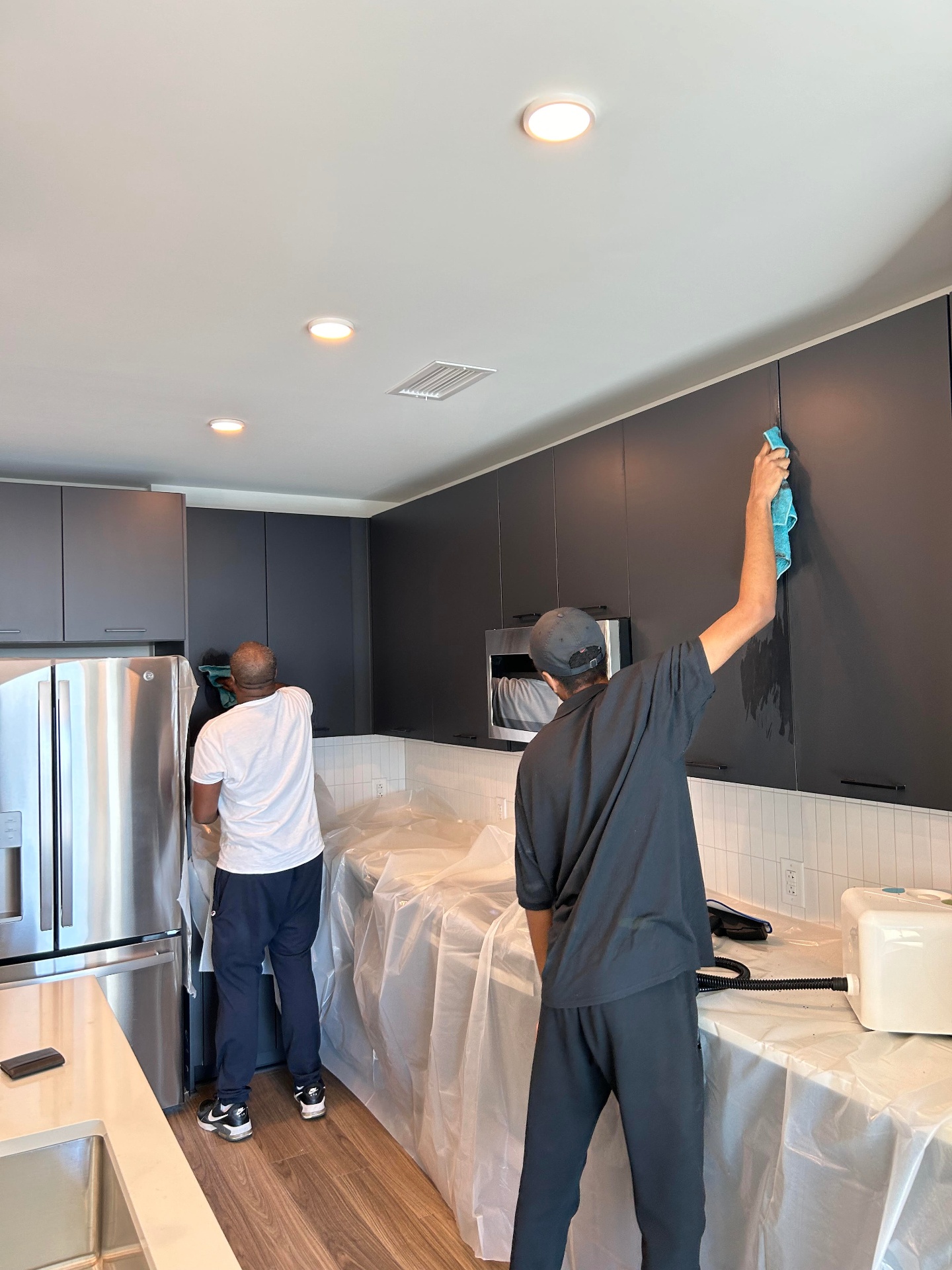 Service In cleaning crew performing a final clean on a commercial upfit