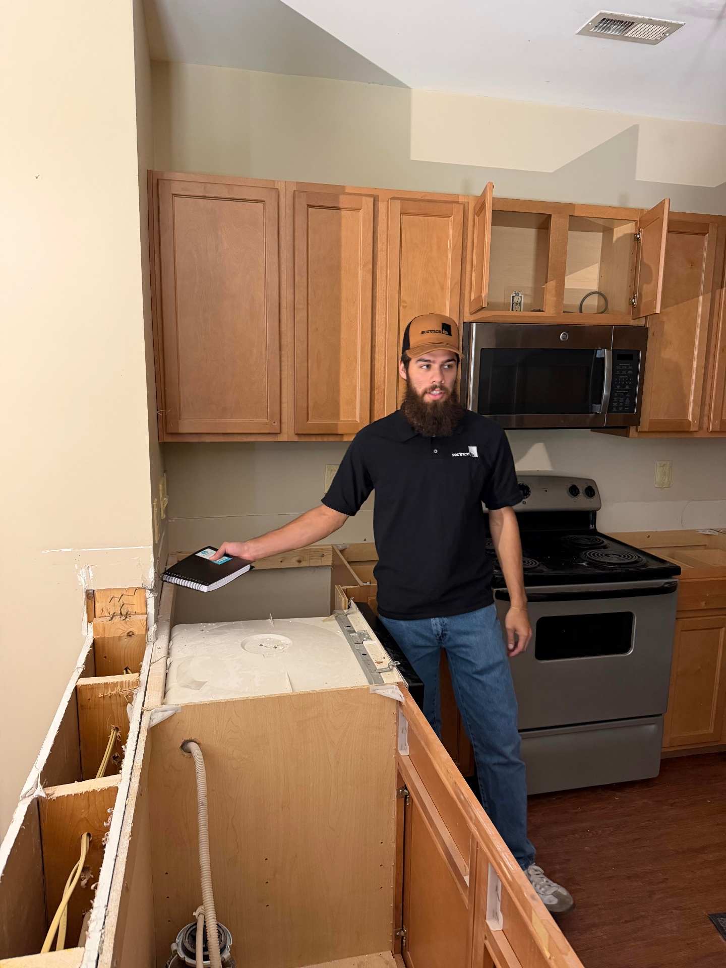 Service In service manager reviewing a punch list inside a unit under construction